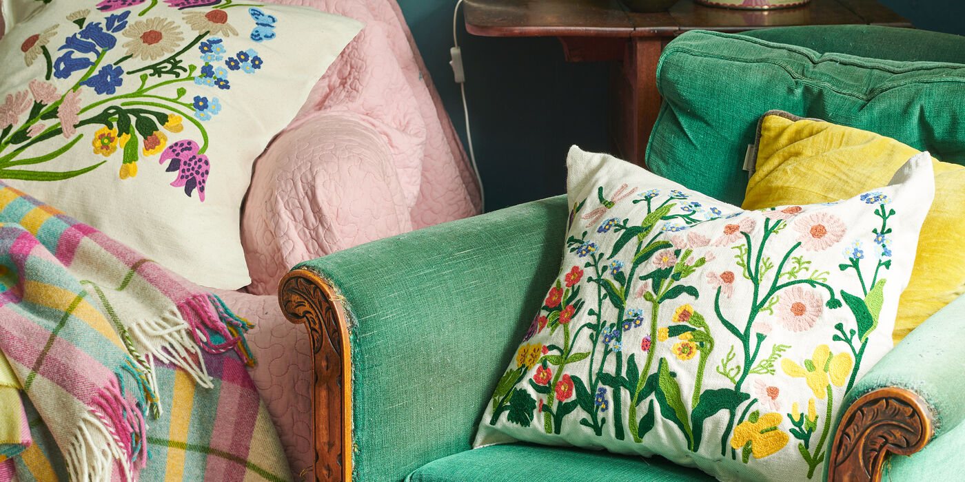 Emma Bridgewater square scatter cushions displayed to showcase the vibrant colours and patterns the collection has. Each side has a different design for easy mixing and matching with your furniture's style. Ideal gift idea.